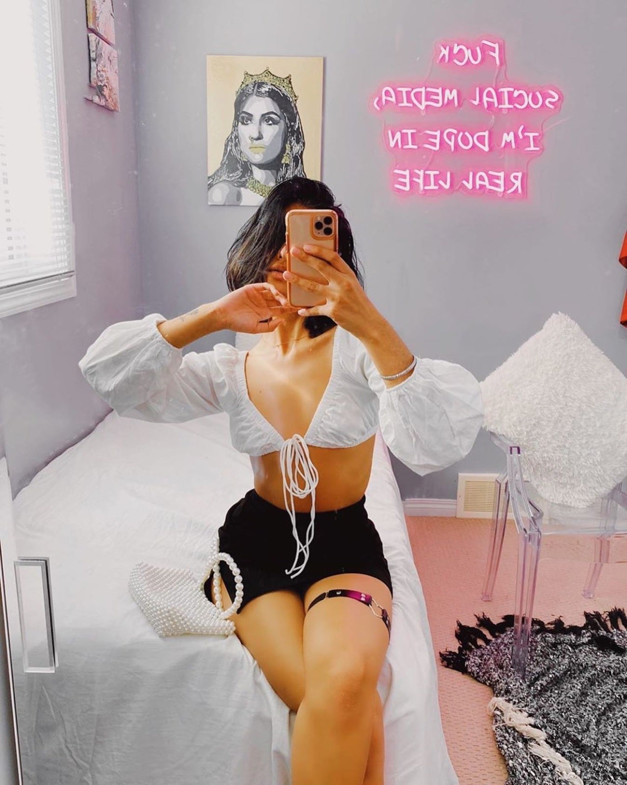 Pink custom quote sign reflected in a bedroom mirror