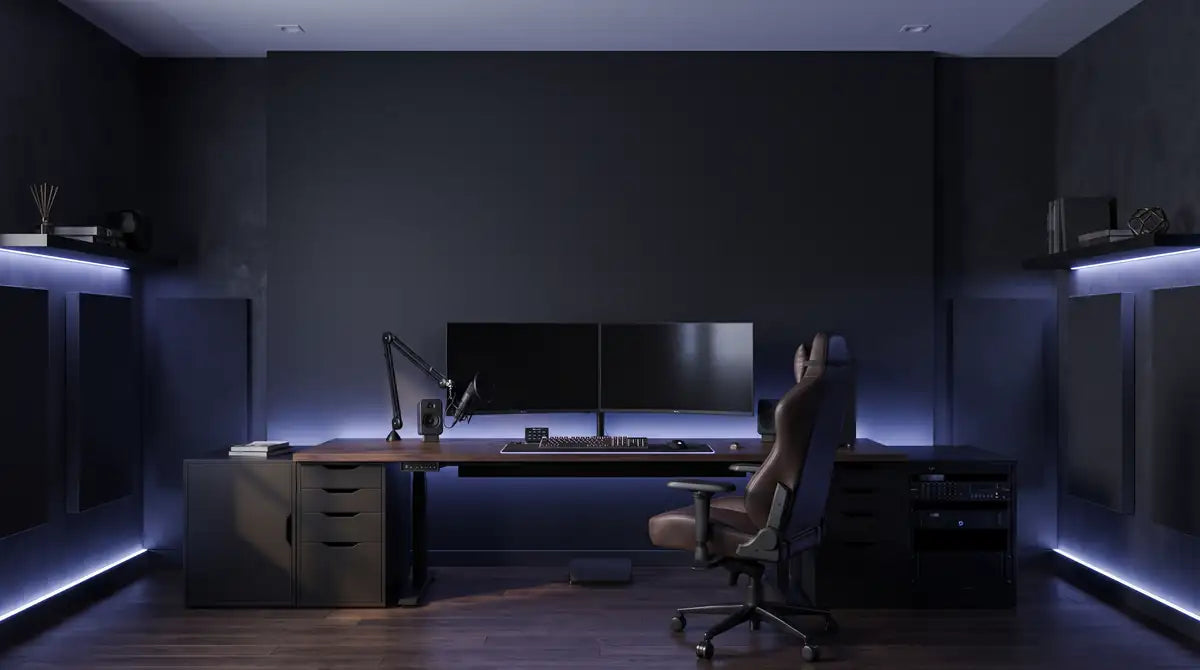 Gaming and streaming desk setup with a custom blue neon sign on the wall