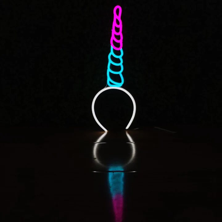 Unicorn Dream neon headband glowing against a dark background