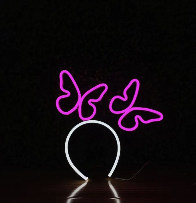 Butterfly Flight neon headband glowing against a dark background