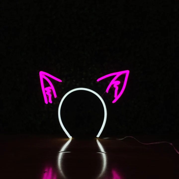 Electric Cat Ears neon headband glowing against a dark background