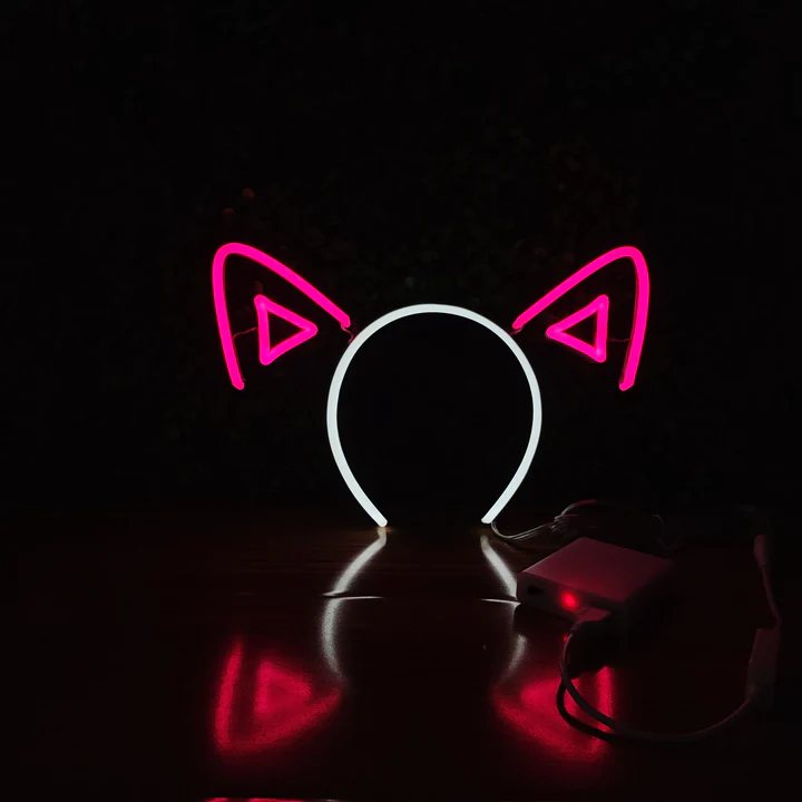 Hot Pink Cat Ears neon headband glowing against a dark background