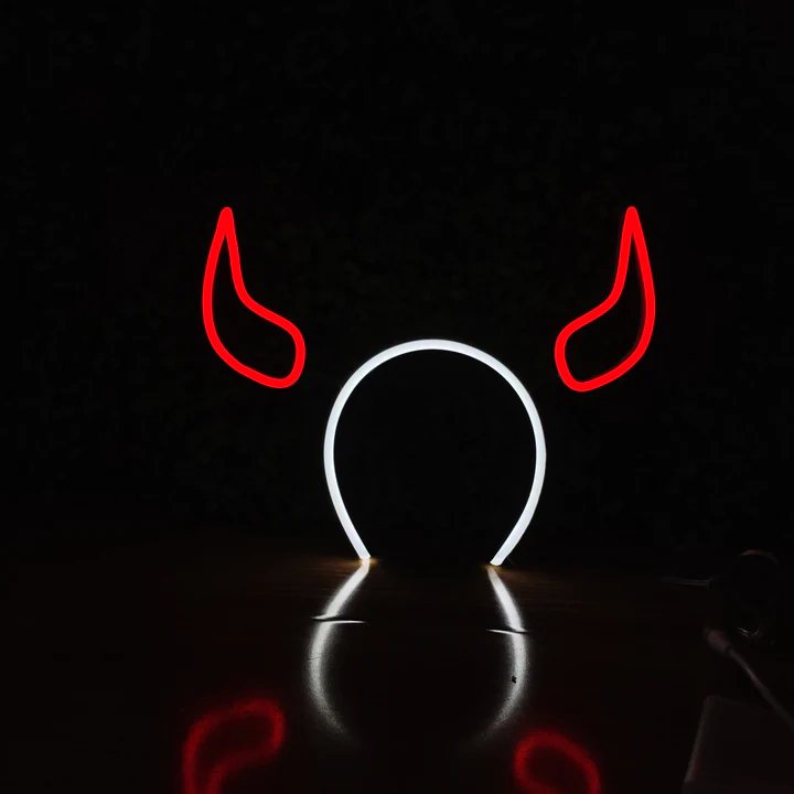 Devil Horns neon headband glowing against a dark background